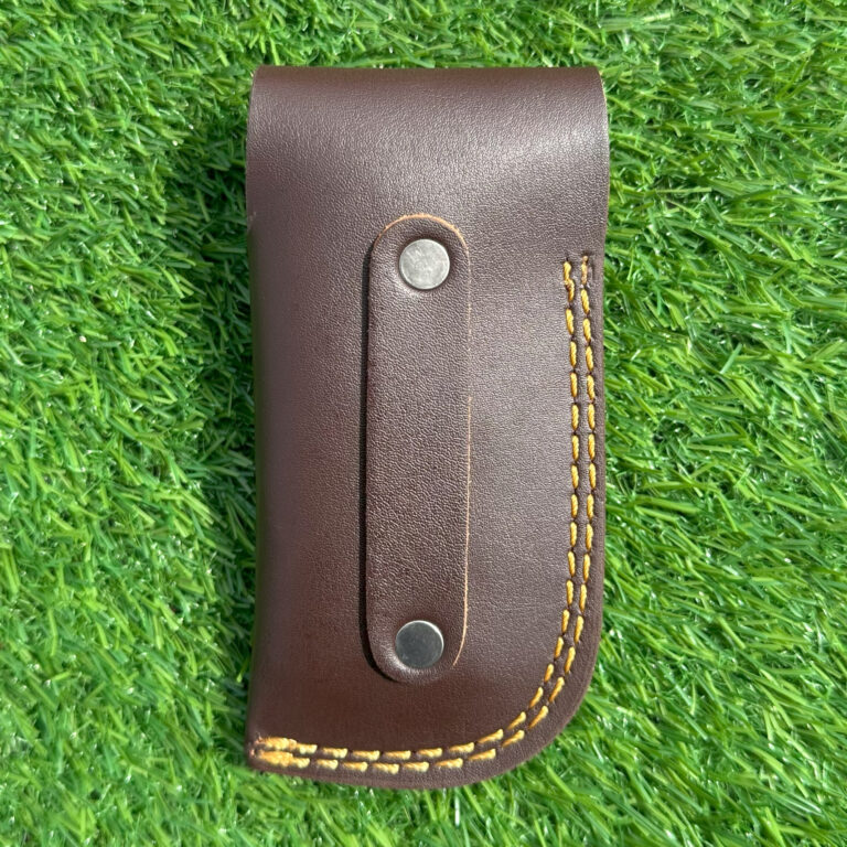 Complete Damascus fish knife set with handcrafted leather sheath on grass