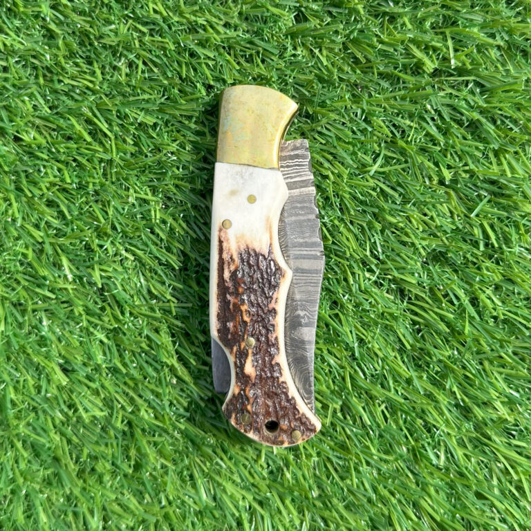 Damascus blade hunting knife closed view showing natural bone handle texture