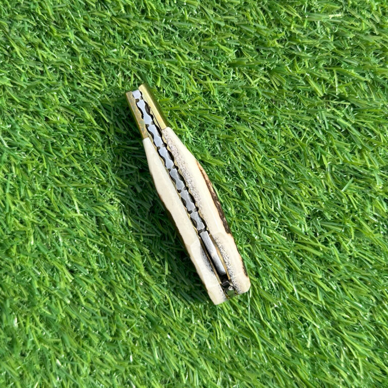 Damascus hunting knife in closed leather sheath showing compact design