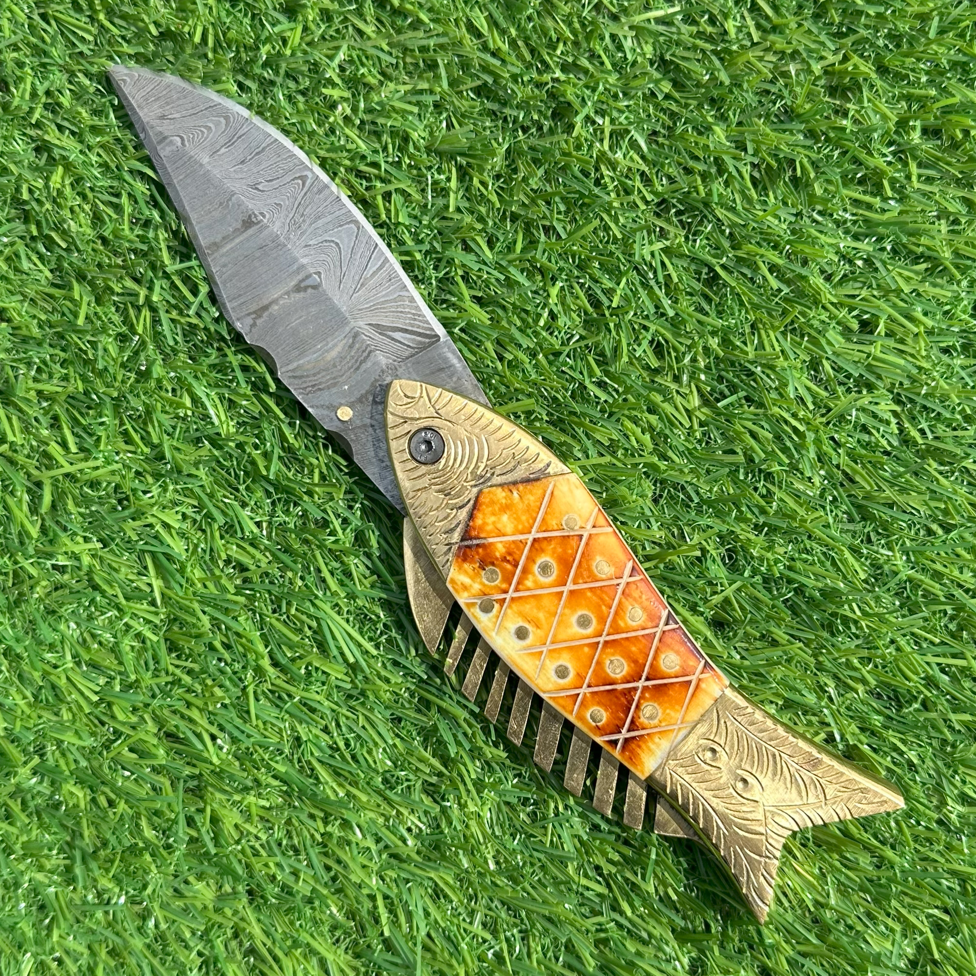 Damascus steel fish knife closed showing artistic design with bone and brass inlay