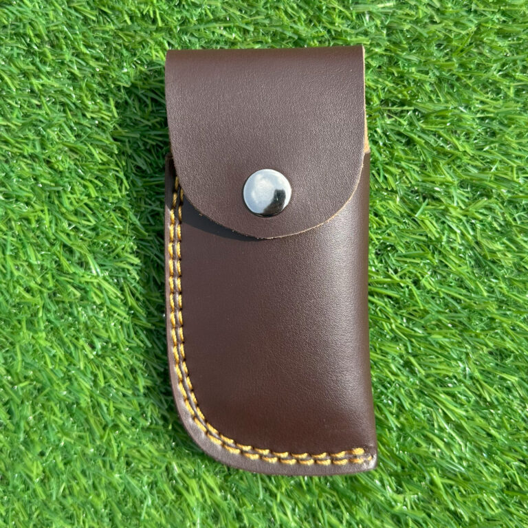 Side view Damascus fish folding knife displaying bone handle with brass wire inlay