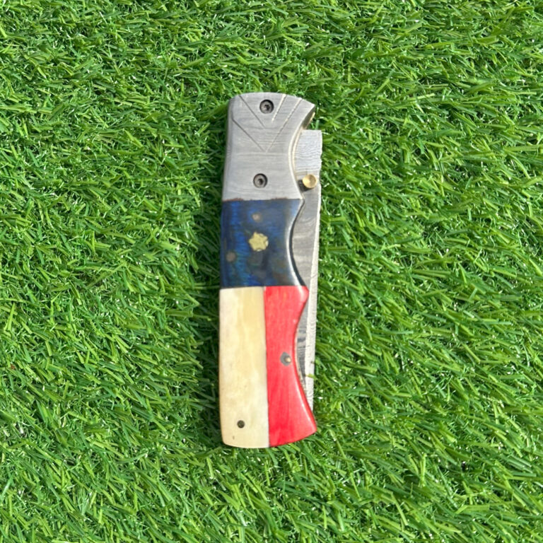 Texas flag Damascus folding knife closed showing red white blue handle with Lone Star